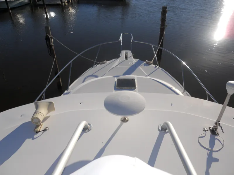 Slide: The Image of Bow view of 2000 Boston Whaler 34 Defiance boat docked on calm water. - 17