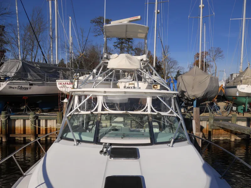 Slide: The Image of Boston Whaler 34 Defiance 2000 boat docked at marina with sailboats in background. - 20