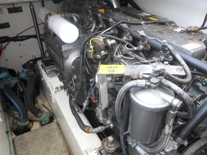 Slide: The Image of Engine compartment of a 2000 Boston Whaler 34 Defiance boat, showcasing detailed machinery. - 25