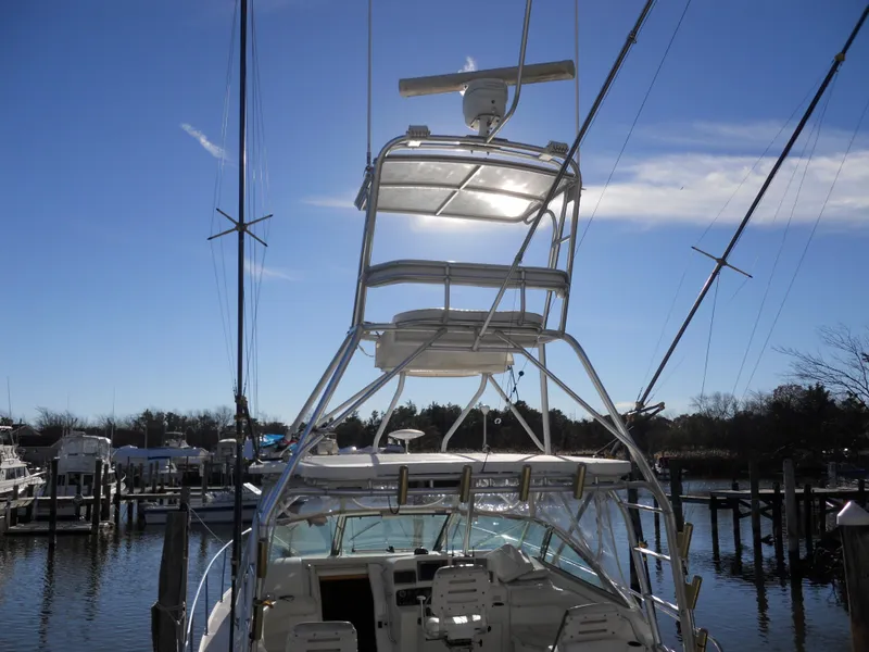 Slide: The Image of Boston Whaler 34 Defiance 2000 boat docked, featuring a tall tower and clear blue sky. - 3