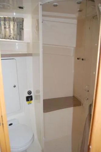 Slide: The Image of Bathroom interior of 2000 Boston Whaler 34 Defiance boat, featuring shower and toilet. - 35