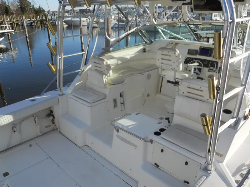 Slide: The Image of Boston Whaler 34 Defiance 2000 model, spacious cockpit with seating and helm, docked at marina. - 7