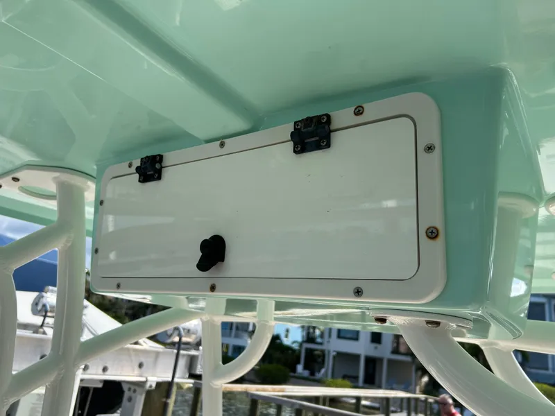 Slide: The Image of 2023 NauticStar 231 Hybrid boat with blue LED lights and rod holders. - 21