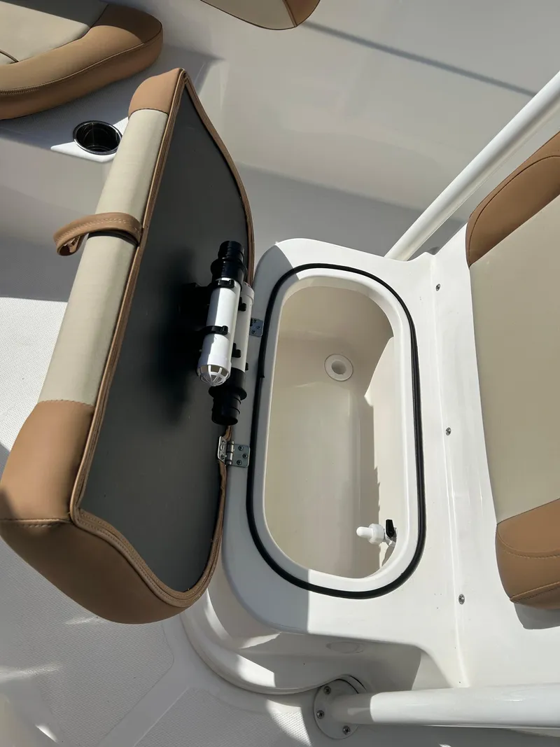Slide: The Image of 2023 NauticStar 231 Hybrid boat interior with cushioned seating and table. - 25
