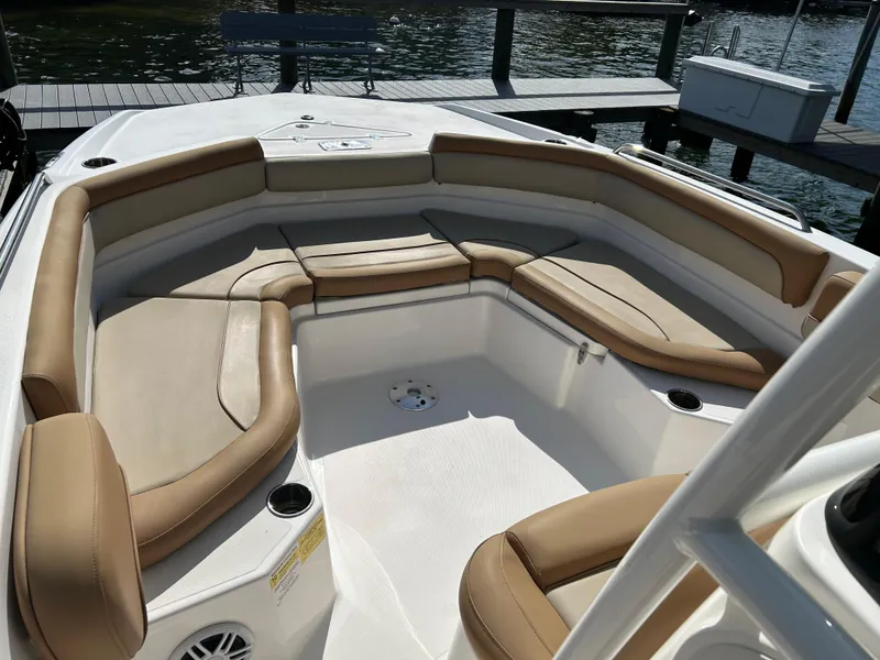 Slide: The Image of 2023 NauticStar 231 Hybrid boat interior with cushioned seating and table. - 26