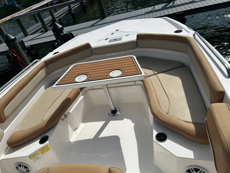 Slide: The Image of 2023 NauticStar 231 Hybrid boat storage compartment with open lid and seating area. - 28