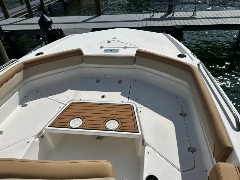Slide: The Image of 2023 NauticStar 231 Hybrid boat storage compartment with cushioned seating. - 29
