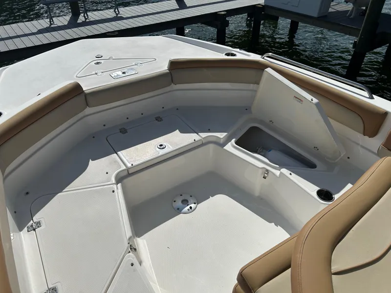 Slide: The Image of 2023 NauticStar 231 Hybrid boat storage compartment with yellow life jackets. - 31