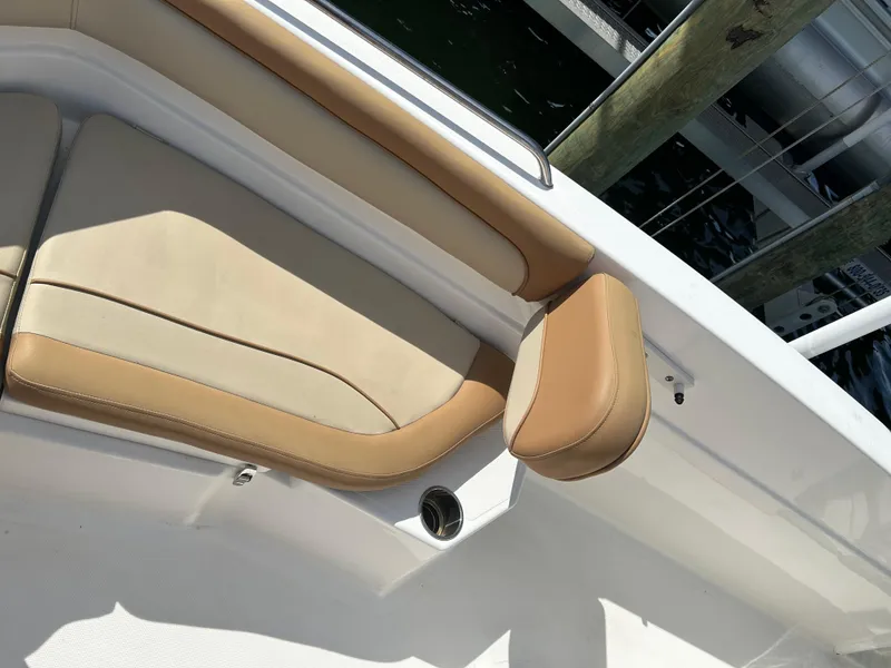 Slide: The Image of 2023 NauticStar 231 Hybrid boat on calm water with coastal view. - 32