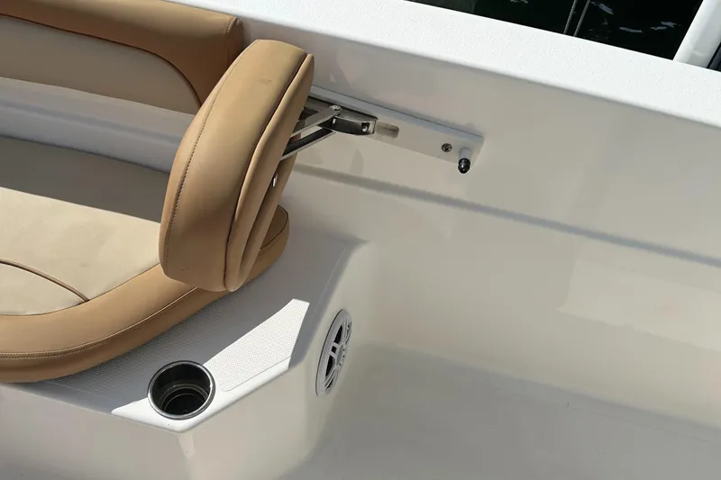 Slide: The Image of 2023 NauticStar 231 Hybrid boat with T-top, docked by the water under a clear blue sky. - 33