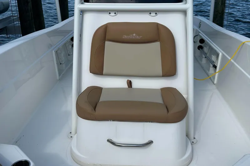 Slide: The Image of 2023 NauticStar 231 Hybrid boat interior with tan cushioned seating arrangement. - 35