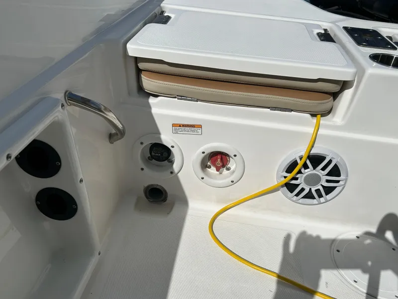 Slide: The Image of 2023 NauticStar 231 Hybrid boat control panel with speaker and warning label. - 42