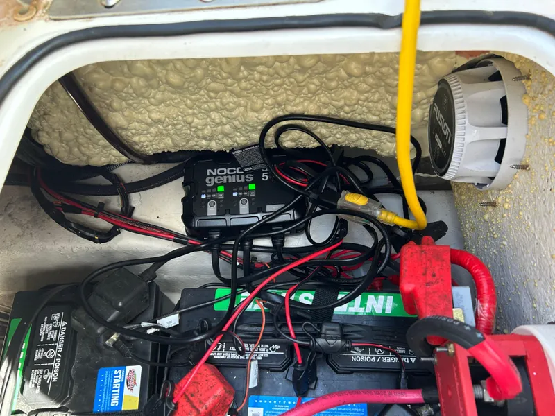 Slide: The Image of 2023 NauticStar 231 Hybrid boat deck with motor, storage compartments, and cup holders. - 45