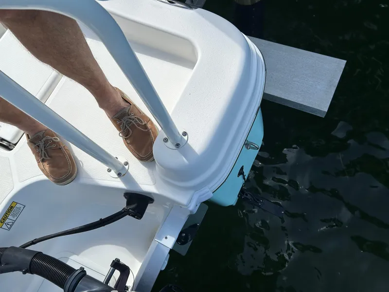 Slide: The Image of 2023 NauticStar 231 Hybrid boat interior with open storage compartments and seating. - 47