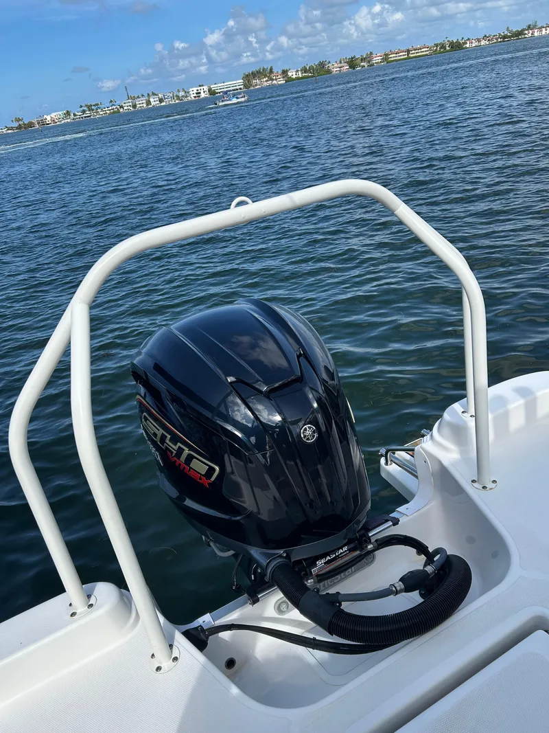 Slide: The Image of 2023 NauticStar 231 Hybrid boat with Yamaha outboard engine and three rear seats. - 48