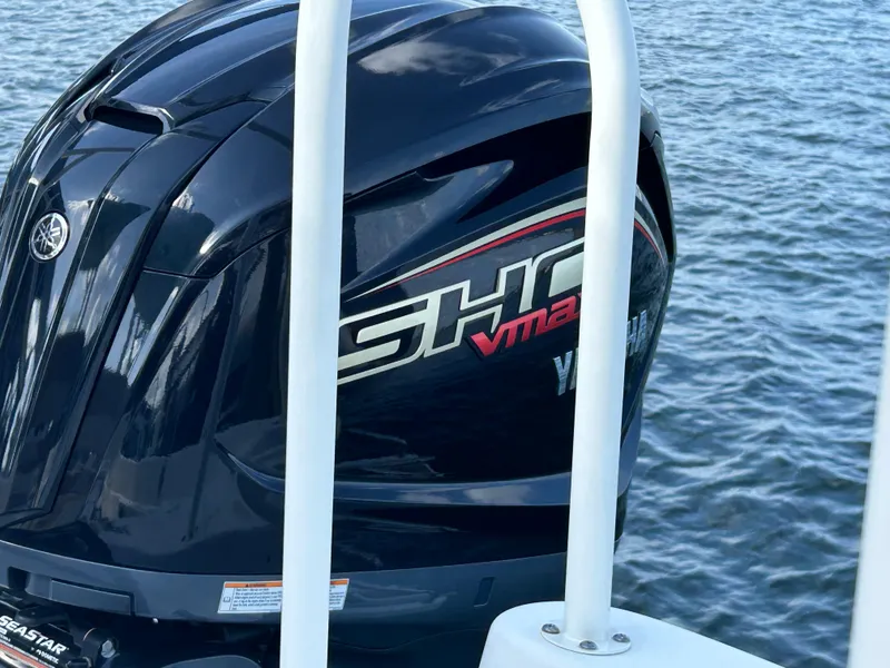 Slide: The Image of 2023 NauticStar 231 Hybrid boat detail at dock with water background. - 50