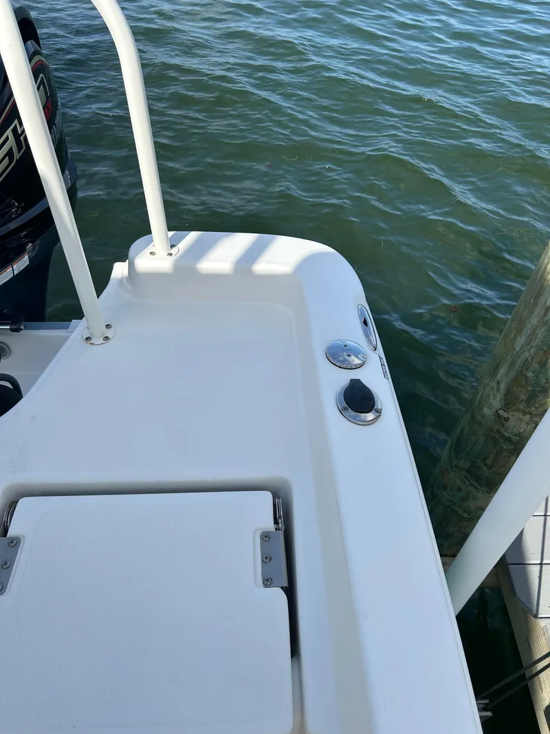 Slide: The Image of 2023 NauticStar 231 Hybrid boat with Yamaha outboard motor on water. - 51