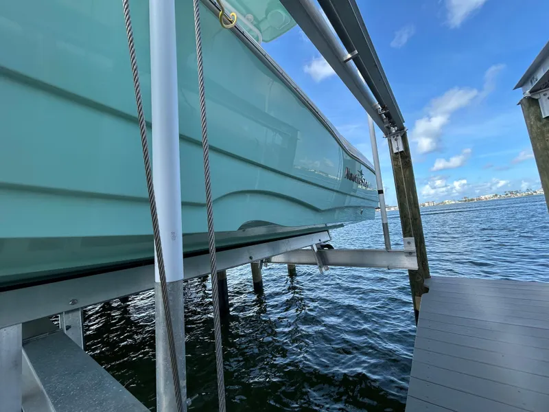 Slide: The Image of 2023 NauticStar 231 Hybrid boat docked with blue sky. - 55