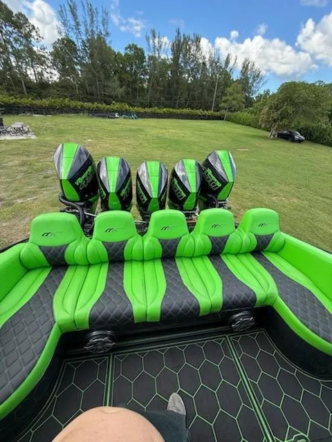 Slide: The Image of 2020 Midnight Express Open 43 boat with vibrant green seating and multiple engines. - 11