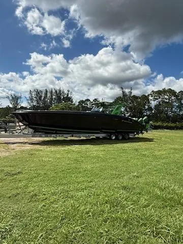 Slide: The Image of 2020 Midnight Express Open 43 boat on trailer under cloudy sky. - 14