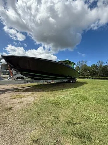 Slide: The Image of 2020 Midnight Express Open 43 boat on trailer under cloudy sky. - 15