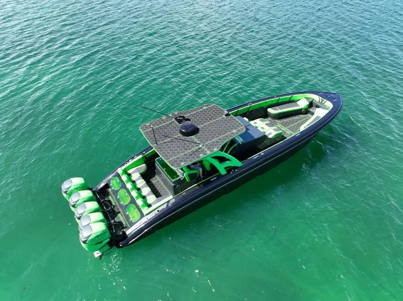 Slide: The Image of 2020 Midnight Express Open 43 boat with vibrant green accents on clear water. - 2