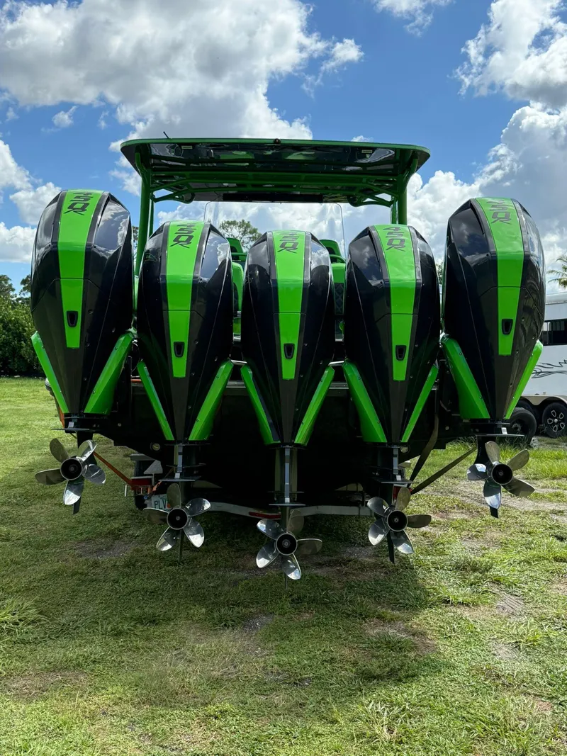 Slide: The Image of Five green and black outboard motors on a 2020 Midnight Express Open 43 boat. - 3