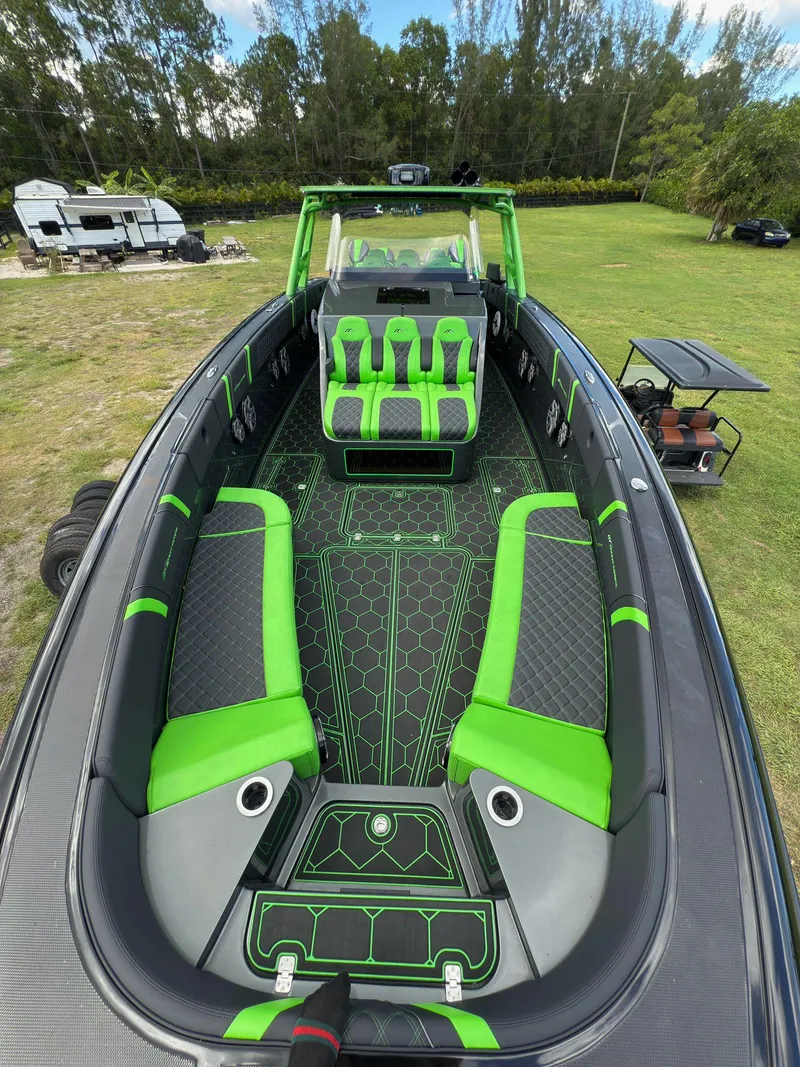 Slide: The Image of 2020 Midnight Express Open 43 boat with vibrant green and black interior design. - 4