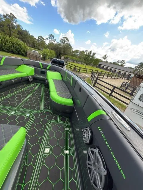 Slide: The Image of 2020 Midnight Express Open 43 boat with green and black interior, parked outdoors. - 5