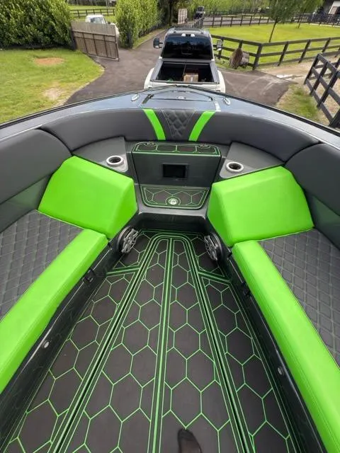 Slide: The Image of 2020 Midnight Express Open 43 boat interior with vibrant green and black seating and flooring. - 6