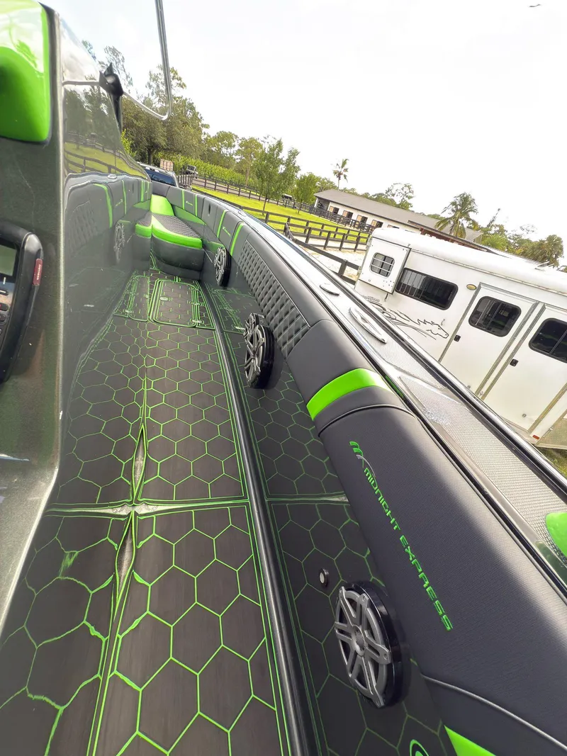 Slide: The Image of 2020 Midnight Express Open 43 boat with sleek green and black interior design. - 8