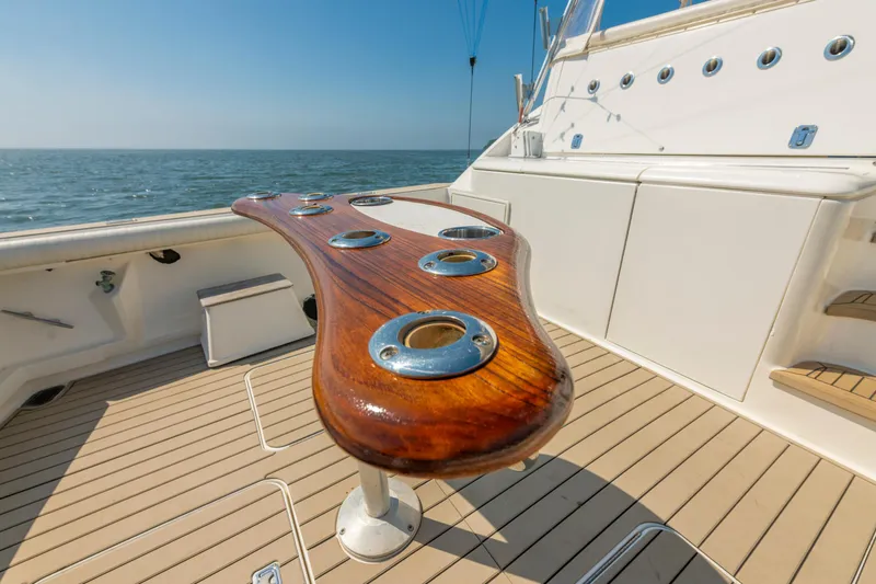 Slide: The Image of 1999 Ocean Yachts 48 Express deck with wooden rod holders, ocean view. - 12