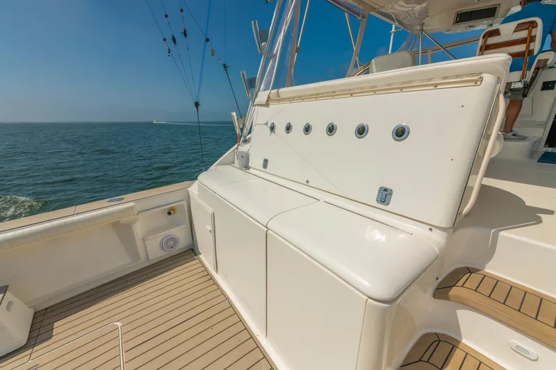 Slide: The Image of 1999 Ocean Yachts 48 Express boat deck with fishing rods and ocean view. - 17