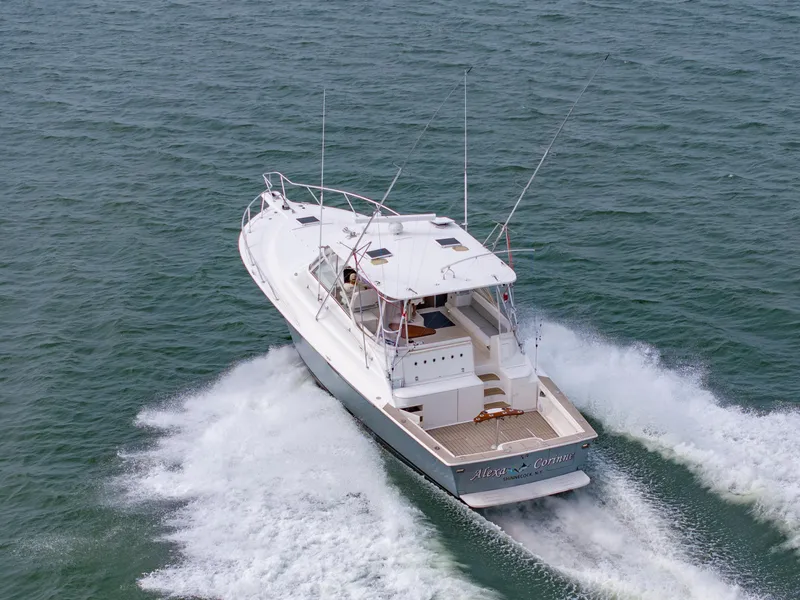 Slide: The Image of 1999 Ocean Yachts 48 Express cruising on open water, rear view. - 2