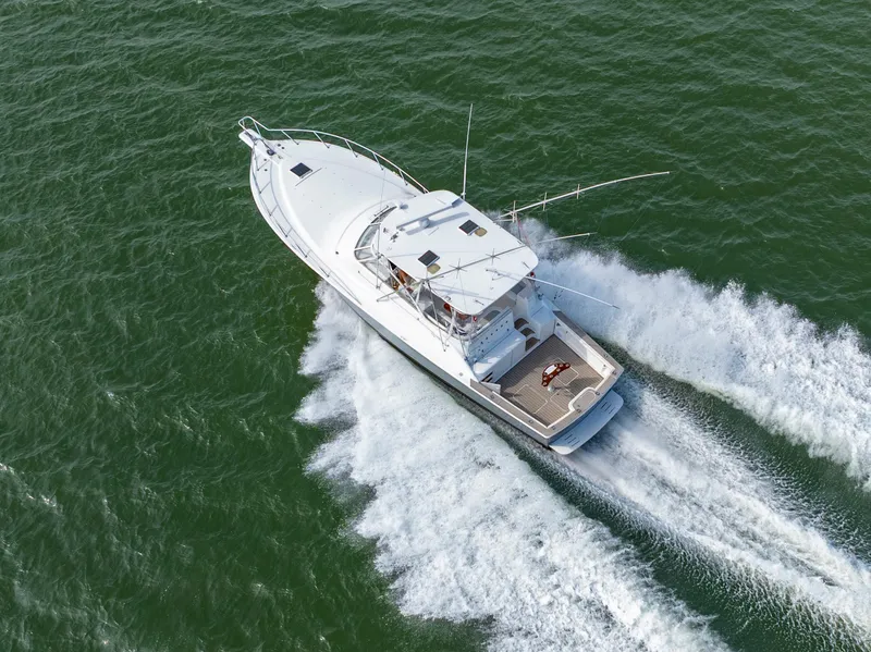 Slide: The Image of 1999 Ocean Yachts 48 Express cruising on open water, aerial view. - 3