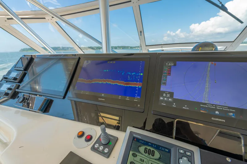 Slide: The Image of Cockpit of 1999 Ocean Yachts 48 Express with Garmin navigation displays and controls. - 33