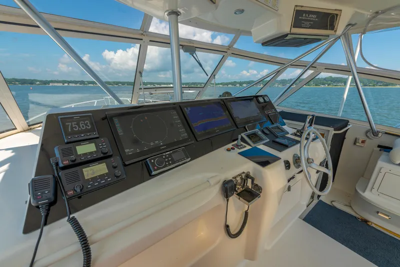 Slide: The Image of Cockpit of 1999 Ocean Yachts 48 Express with navigation equipment and ocean view. - 34