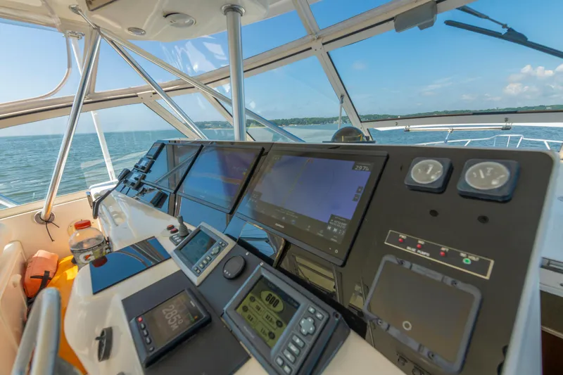 Slide: The Image of Cockpit view of 1999 Ocean Yachts 48 Express, featuring navigation instruments and ocean scenery. - 35