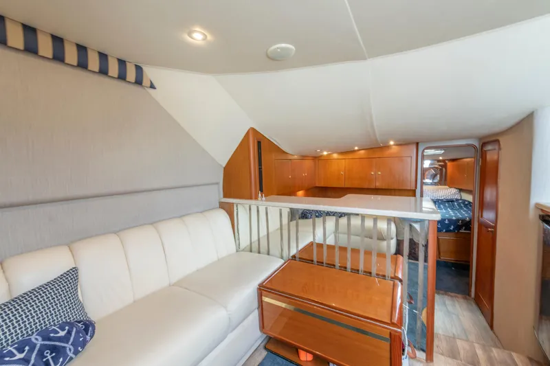 Slide: The Image of Luxurious interior of 1999 Ocean Yachts 48 Express with elegant seating and wooden cabinetry. - 39