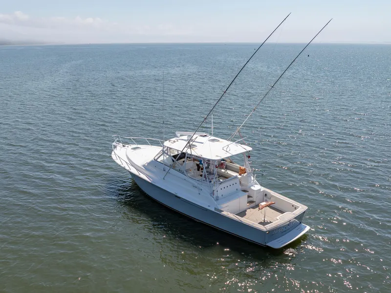 Slide: The Image of 1999 Ocean Yachts 48 Express boat on calm water, aerial view. - 4