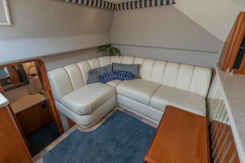 Slide: The Image of Luxurious interior of 1999 Ocean Yachts 48 Express with white leather seating and nautical decor. - 40