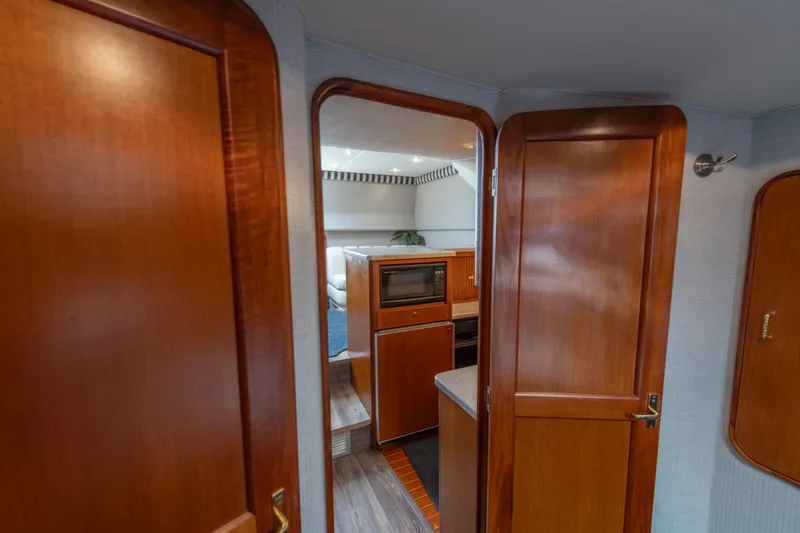 Slide: The Image of Interior of 1999 Ocean Yachts 48 Express, featuring wooden cabinetry and modern kitchen amenities. - 46