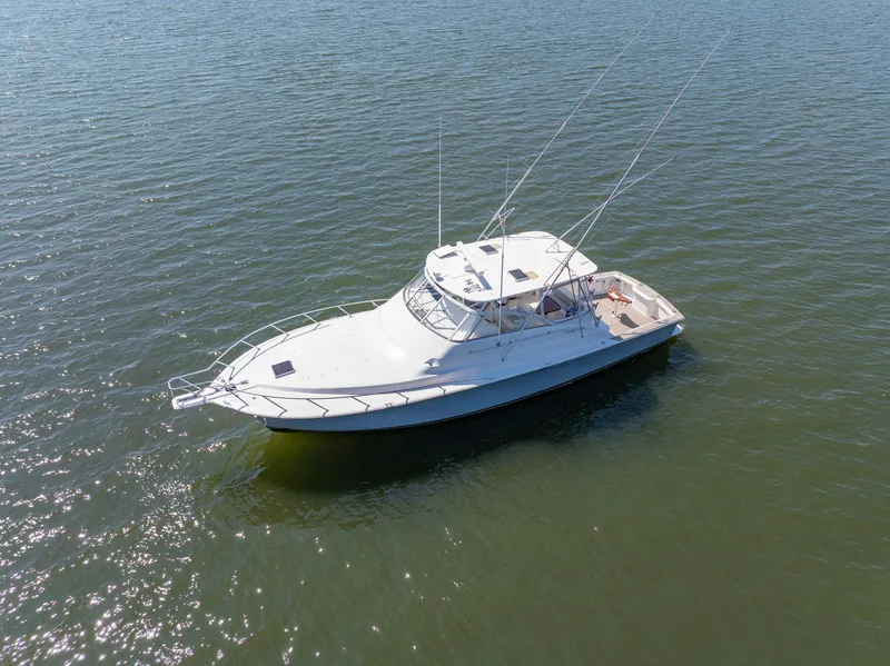 Slide: The Image of 1999 Ocean Yachts 48 Express boat on calm water, aerial view. - 5