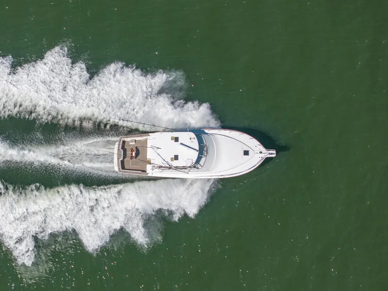 Slide: The Image of Aerial view of 1999 Ocean Yachts 48 Express cruising on open water. - 7