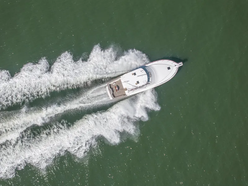 Slide: The Image of Aerial view of 1999 Ocean Yachts 48 Express cruising on open water. - 8