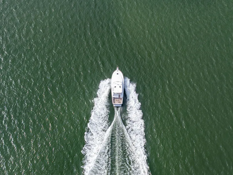 Slide: The Image of Aerial view of 1999 Ocean Yachts 48 Express cruising on open water. - 9