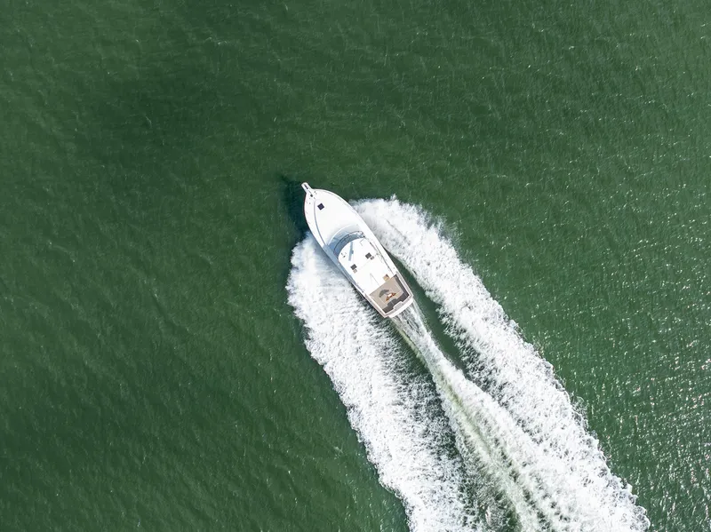 Slide: The Image of Aerial view of 1999 Ocean Yachts 48 Express cruising on open water. - 10