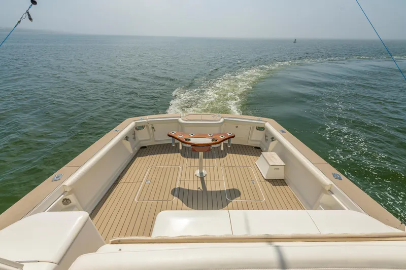 Slide: The Image of 1999 Ocean Yachts 48 Express boat deck with ocean view and fishing setup. - 22