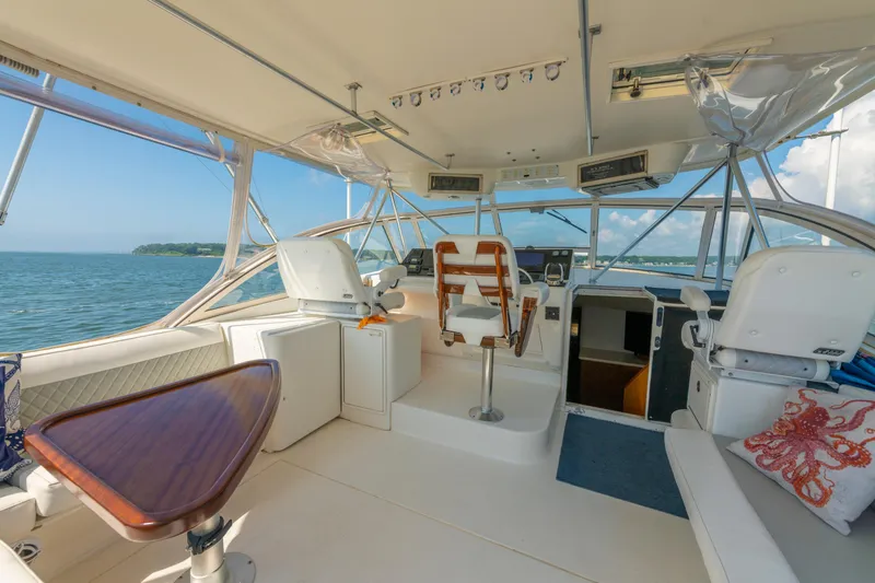 Slide: The Image of 1999 Ocean Yachts 48 Express interior with helm, seating, and ocean view. - 24