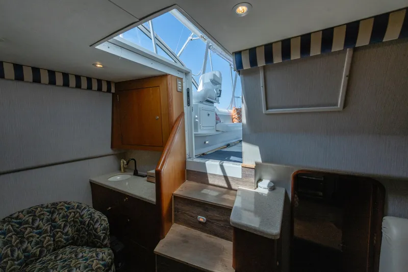 Slide: The Image of Interior view of 1999 Ocean Yachts 48 Express, featuring stairs and seating area. - 38
